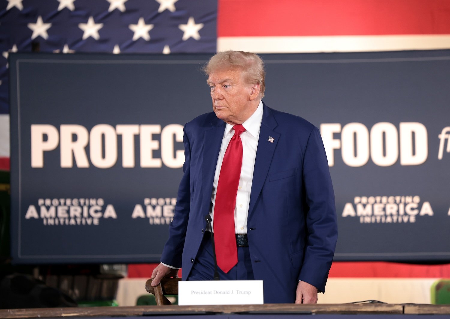 Donald Trump appears in front of a banner that reads 'Protect Our Food'