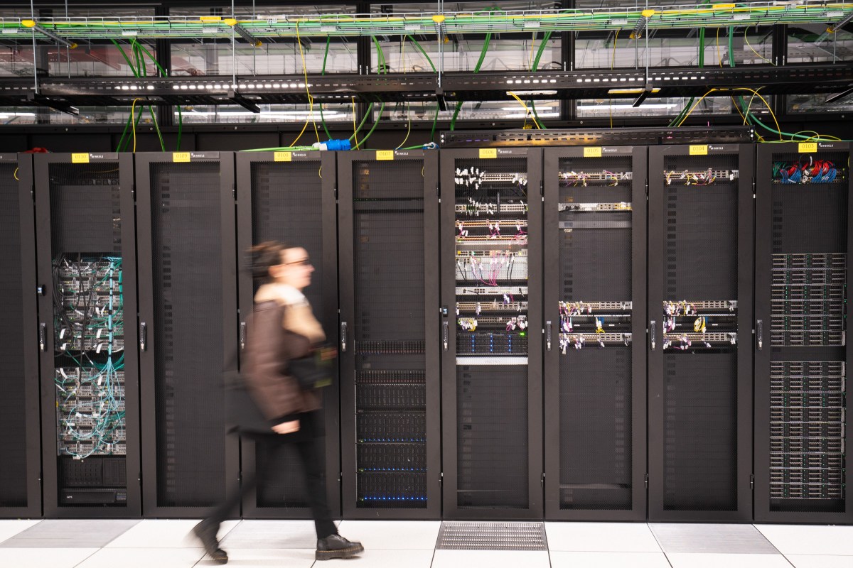 A visitor walks past a computer bay at the PA10 data center, operated by Equinix Inc., in Paris, France.