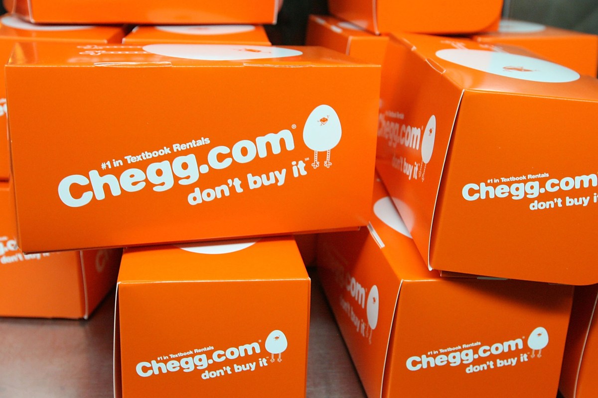 A collection of orange boxes with Chegg branding on a table.