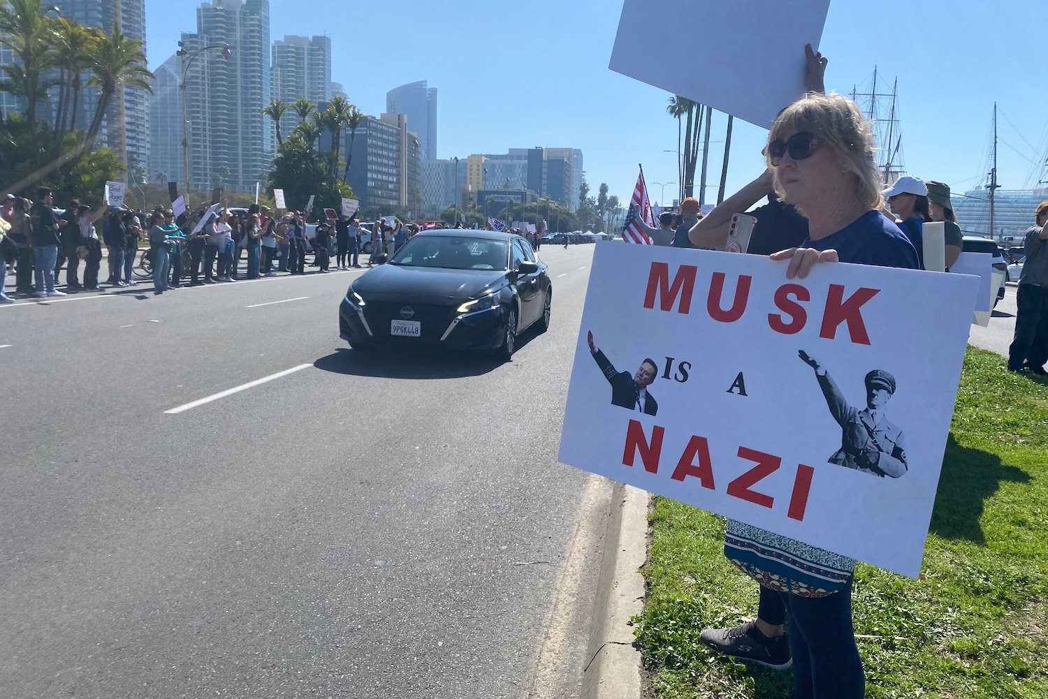 A protester holds a sign that reads "Musk is a Nazi" at a protest on Feb. 17, 2025 in San Diego, California.