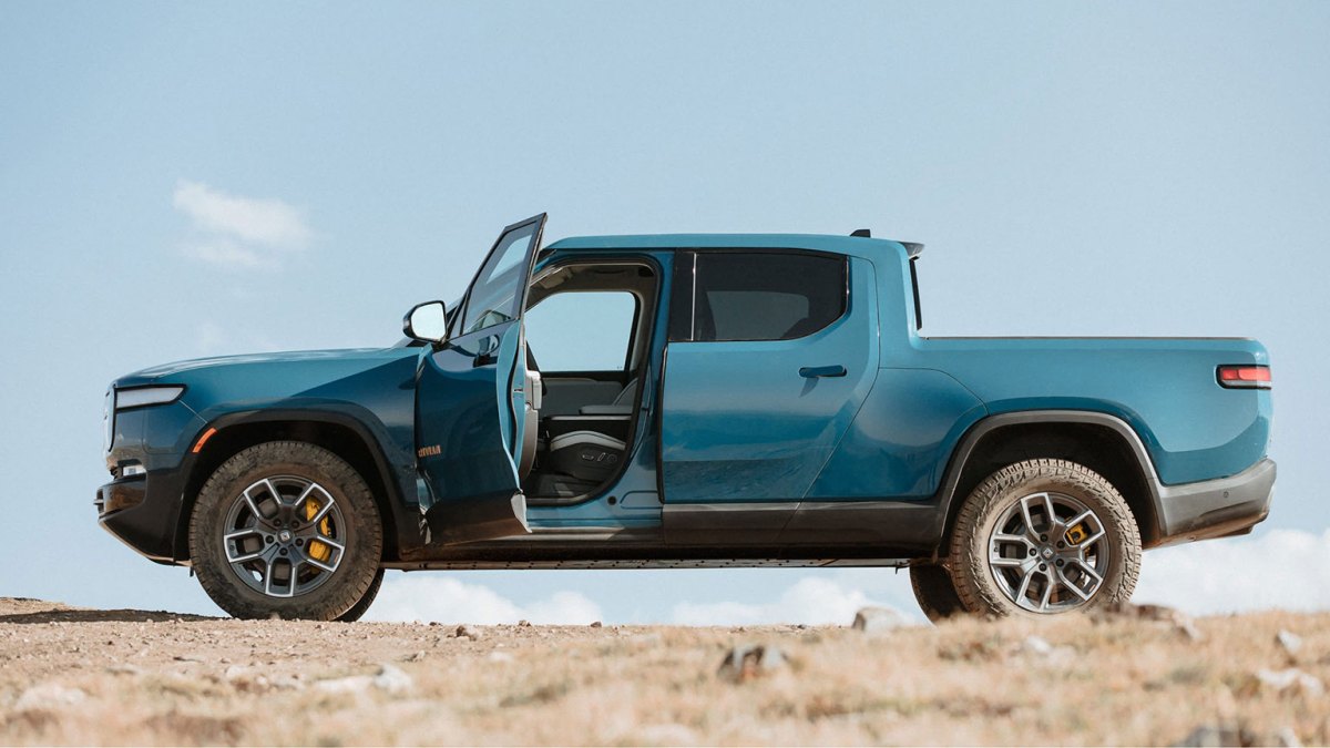 Blue Rivian R1T side view, driver door open