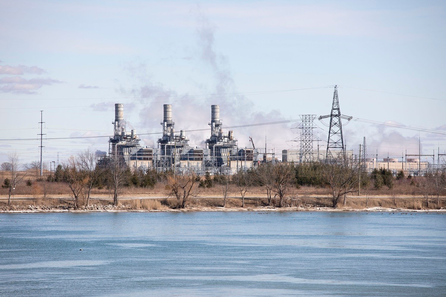 High-voltage power lines cross the St. Clair River between Canada (background) and the United States on March 8, 2025 in East China Township, Michigan.