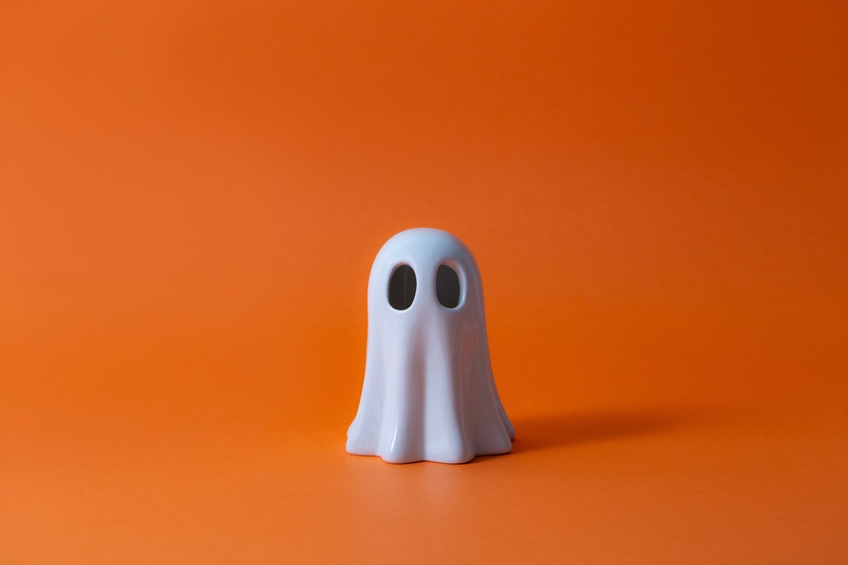 Cute Halloween Ghost over orange background.