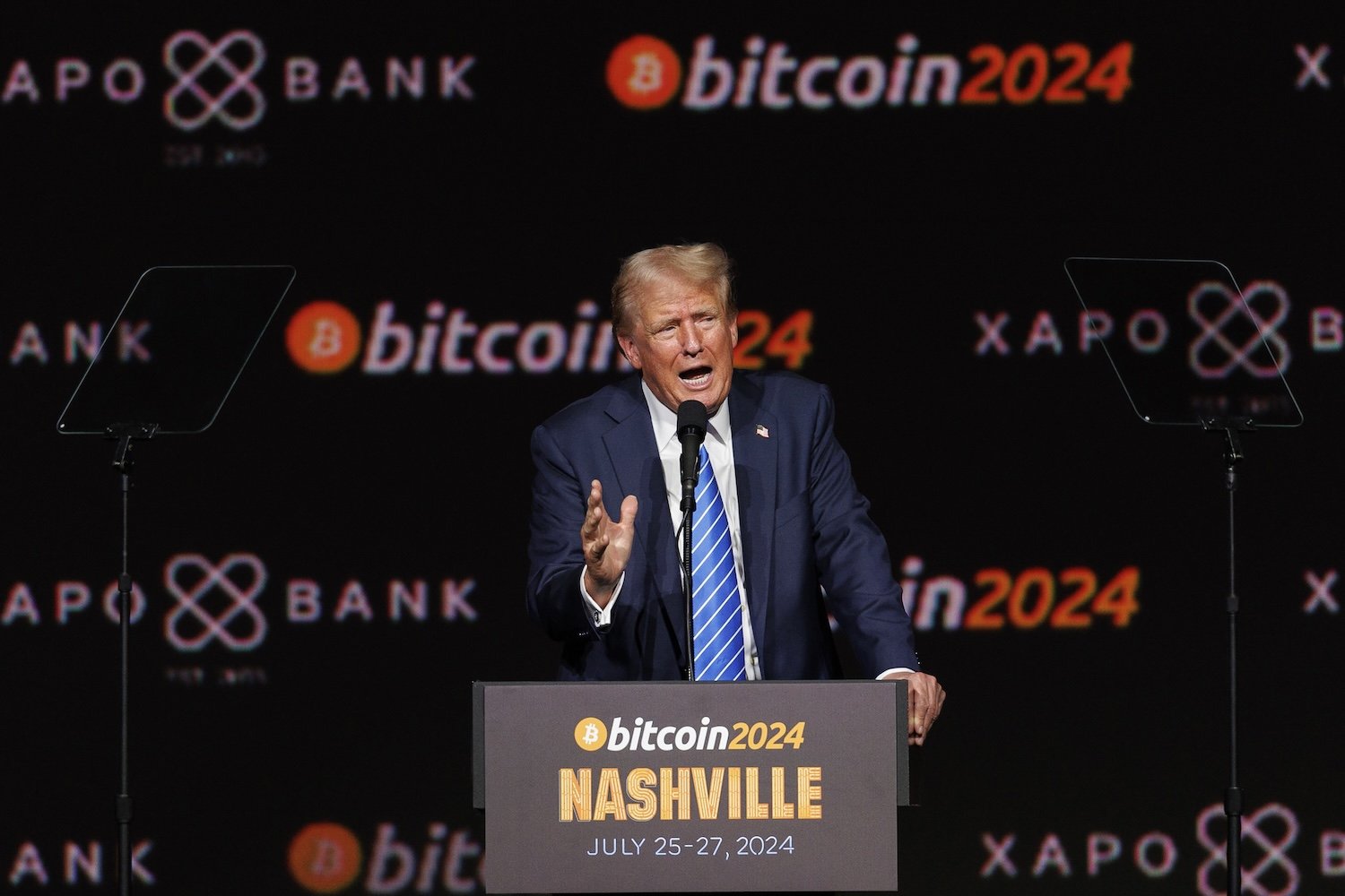 Donald Trump stands in front of a podium and speaks at a Bitcoin conference