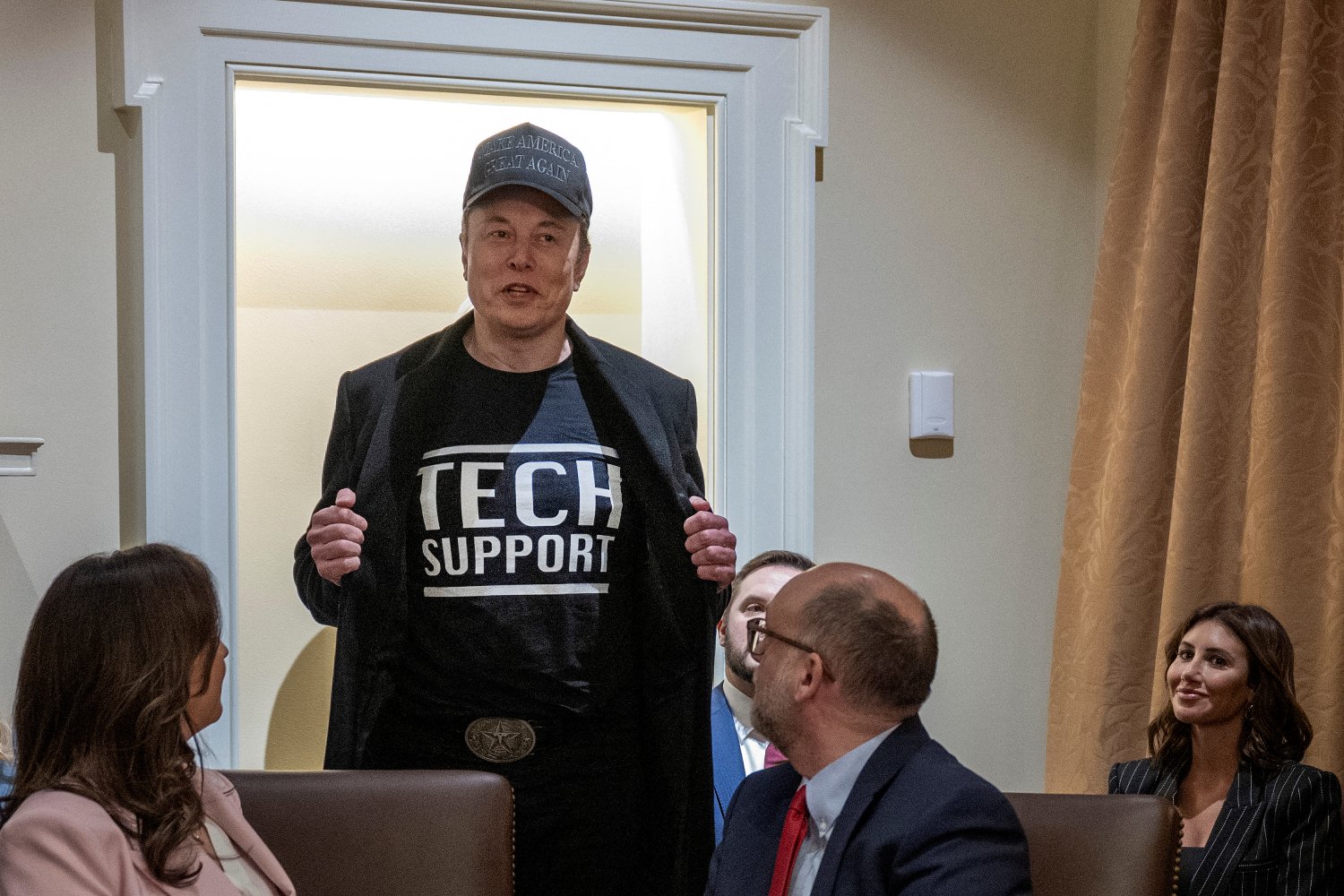 Elon Musk wears a shirt that says "Tech Support" as he speaks during a cabinet meeting