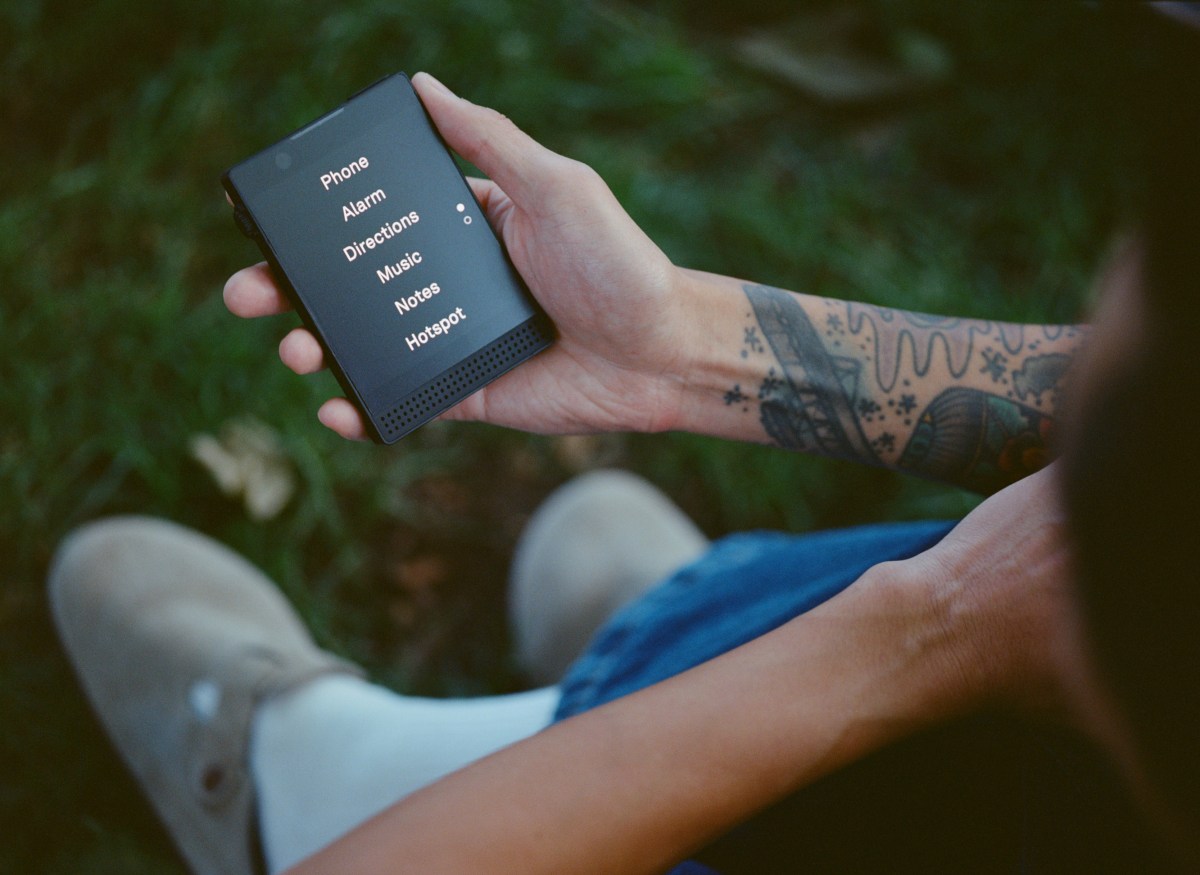 person holding a Light Phone