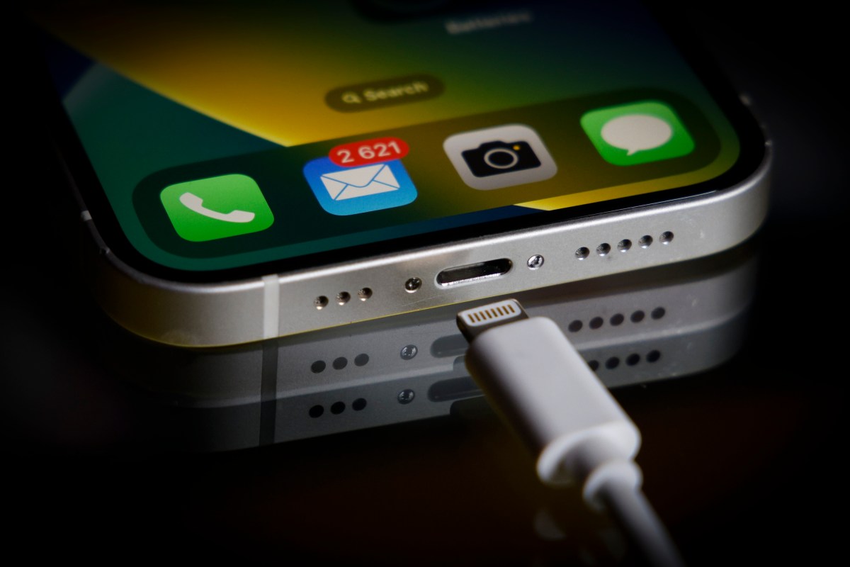 A Apple Lightning port charging cable is seen with with an iPhone in this illustration photo in Warsaw, Poland on 05 October, 2022.