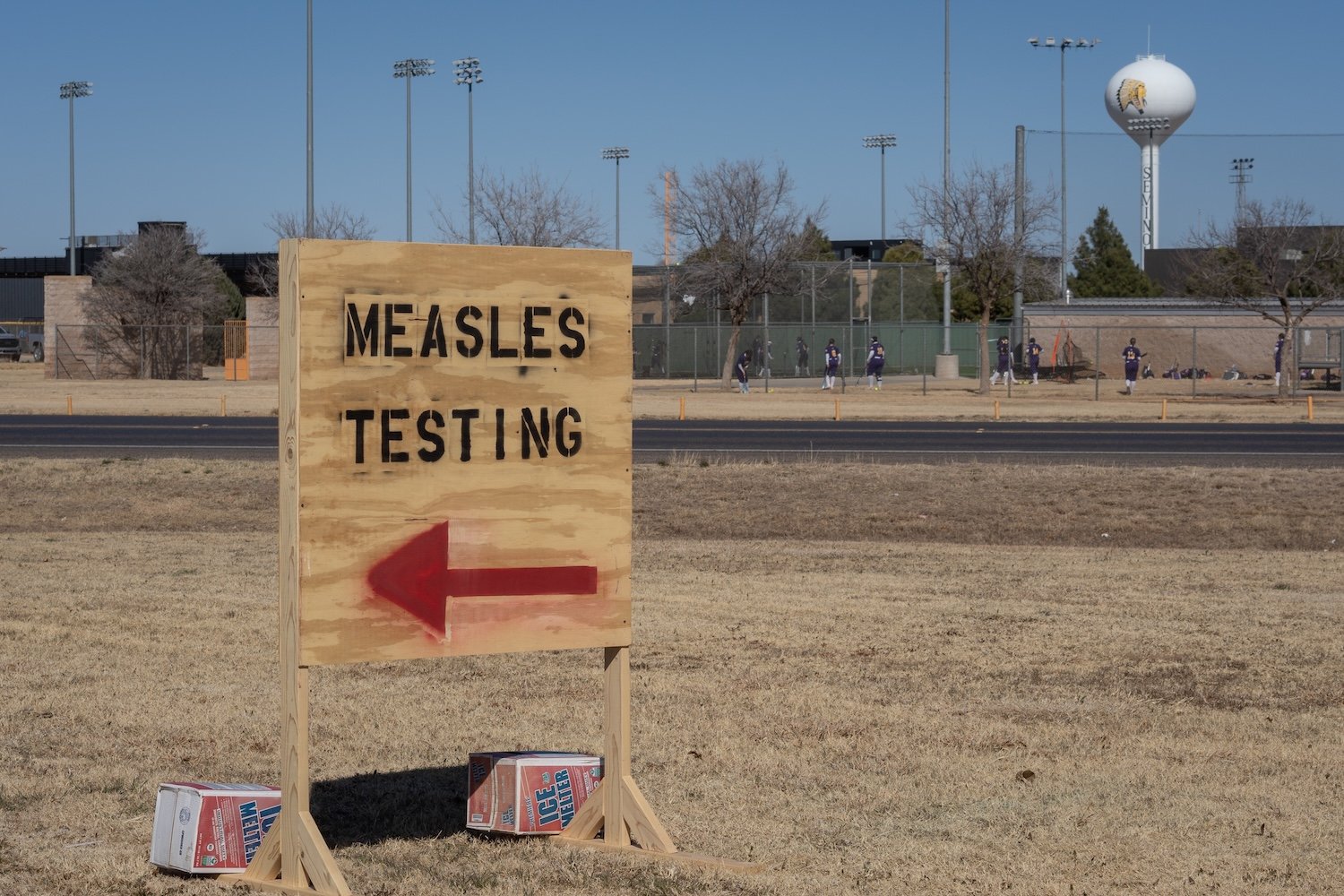 Signs point the way to measles testing in the parking lot of the Seminole Hospital District across from Wigwam Stadium on February 27, 2025 in Seminole, Texas