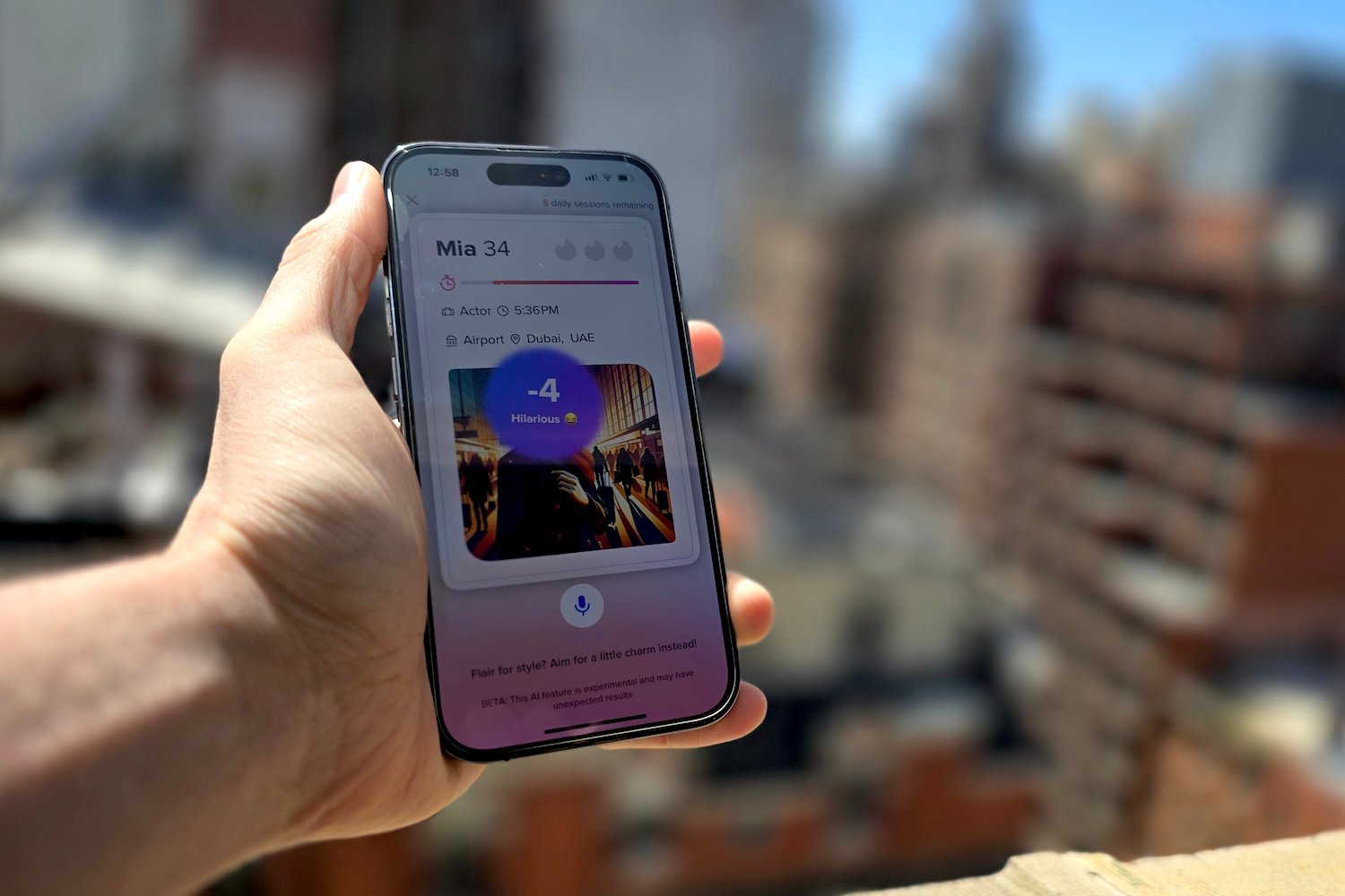 An image of a hand holding a phone, the new The Game Game feature on Tinder is visible.