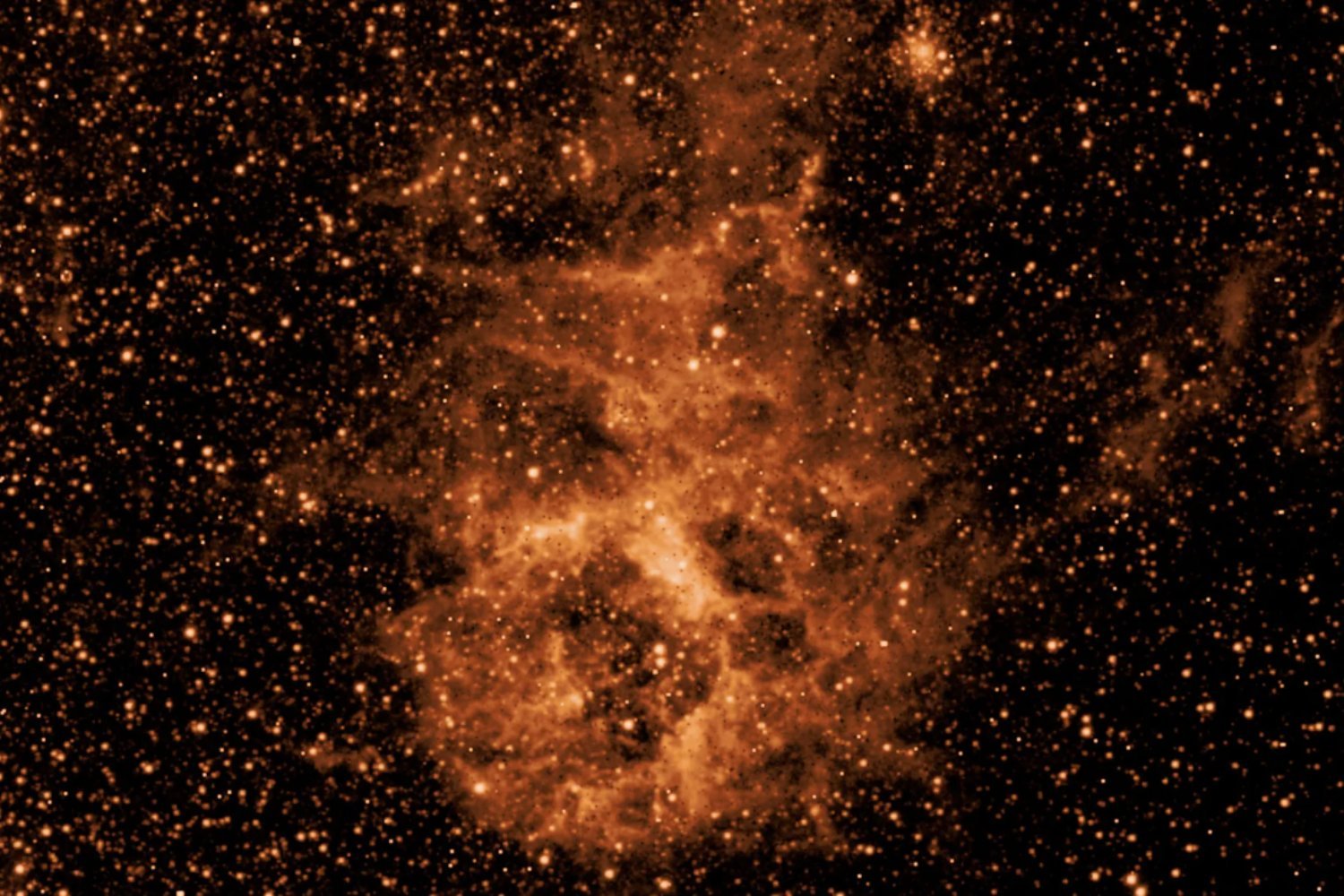 An infrared image of a section of space filled with a smokelike cloud.